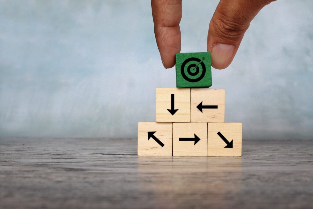 Wooden cubes with target icon and arrow pointing different direction